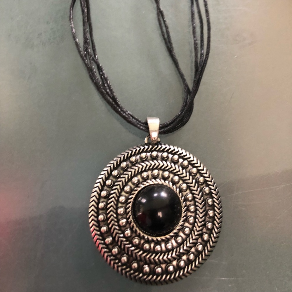 Costume necklace with large charm.
